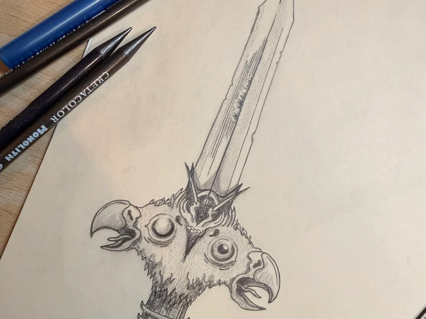 A pencil sketch of an ornate sword with two eagle heads forming the guard